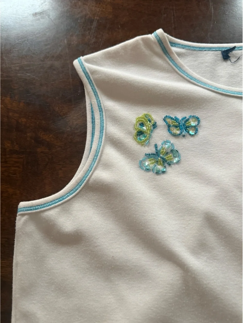 White Sleeveless Top with Beaded Butterfly Embellishments